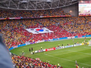 Symbolising the Asian Cup. While the Korean fans had their ‘end’ and their banner, the fans of both teams were mixed throughout the stadium. Photo: Roy Hay.